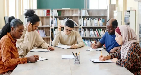 Pensive-Migrant-Students-Doing-Test