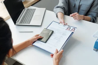 Woman Applying for Visa at Table
